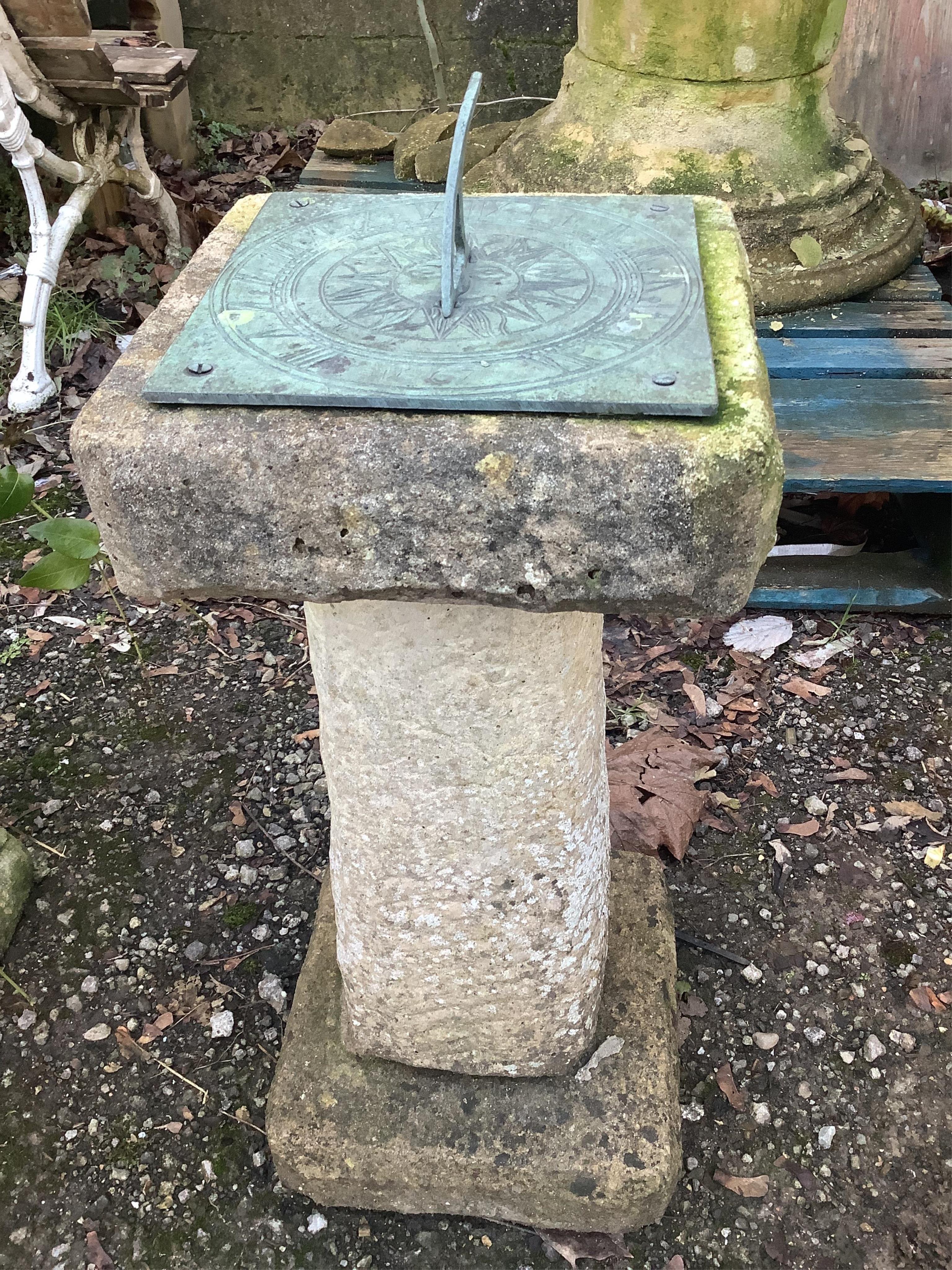 A cast metal sun dial on reconstituted stone base, height 70cm. Condition - fair